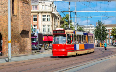 Tram passing through the historic center of The Hague during a city exploration game.