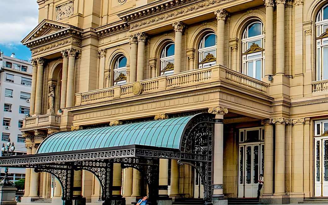 Teatro Colon entrance with ornate columns and decorative canopy in Buenos Aires.