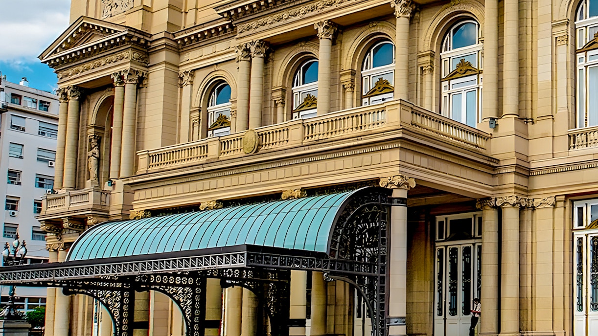 Teatro Colon entrance with ornate columns and decorative canopy in Buenos Aires.