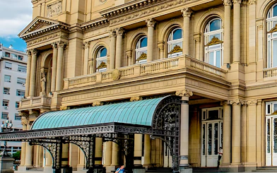 Teatro Colon entrance with ornate columns and decorative canopy in Buenos Aires.