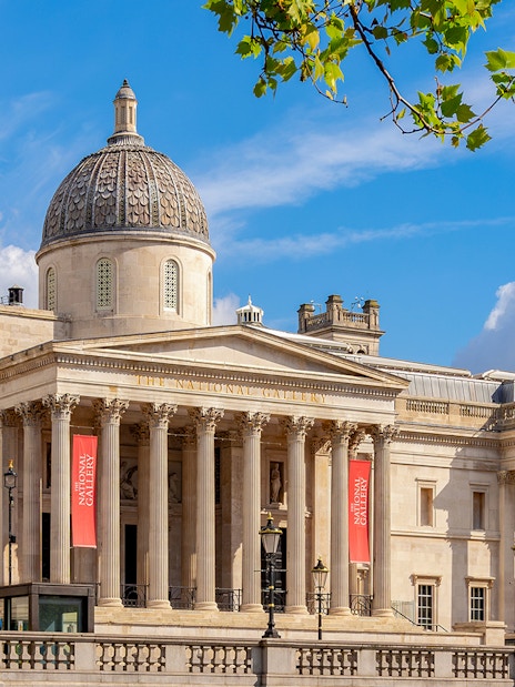 National Gallery London exterior with dome and columns under blue sky.