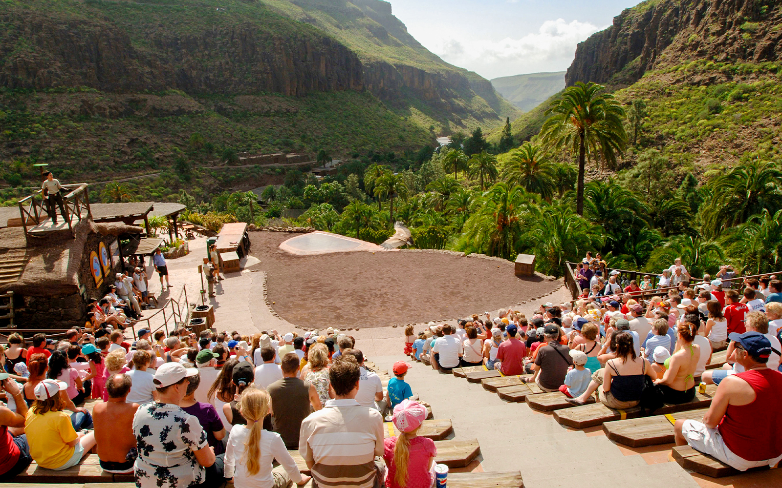 Tourists seated in an amphitheater watching an animal show at Palmitos Park, Gran Canaria.