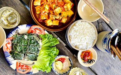 Traditional Vietnamese meal with rice, tofu, and vegetables served on the Sapa 1 Day Tour.