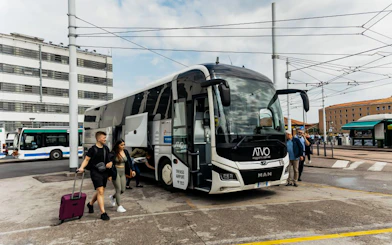 Passengers boarding ATVO airport transfer bus in Venice.
