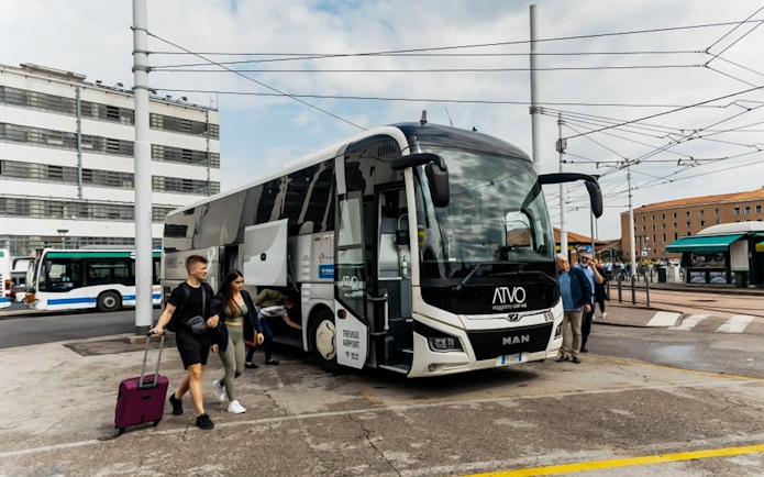 Passengers boarding ATVO airport transfer bus in Venice.