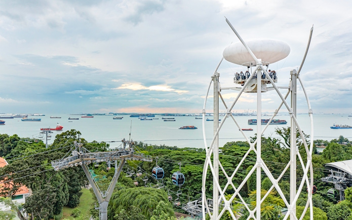 SkyHelix Sentosa ride with panoramic views of Singapore's coastline and cable cars.