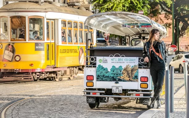 Tuk-tuk parked near Lisbon's iconic Tram 28 route.