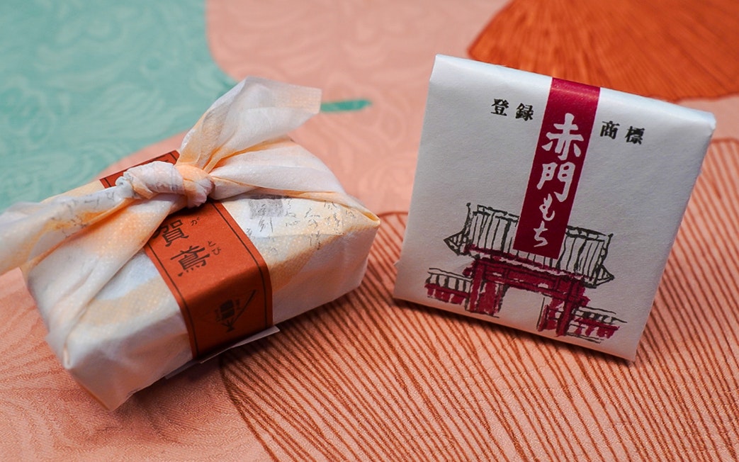 Wrapped Japanese sweets on a textured fabric surface.