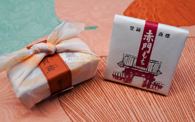 Wrapped Japanese sweets on a textured fabric surface.