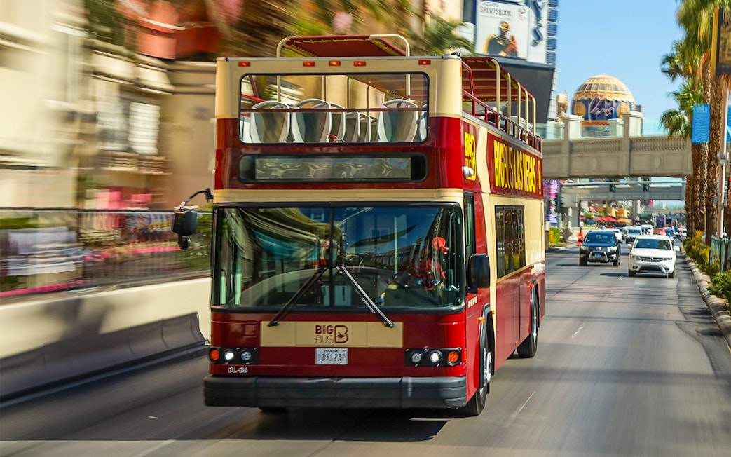 Las Vegas double-decker bus on a city street during a hop-on hop-off tour.