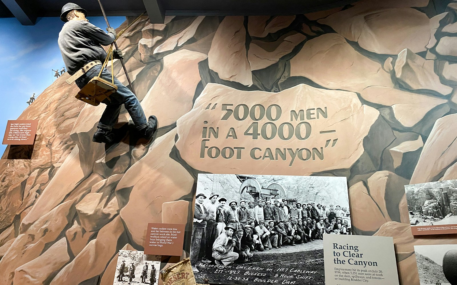 Hoover Dam worker mural and historical photo exhibit at Boulder City and Hoover Dam Museum.