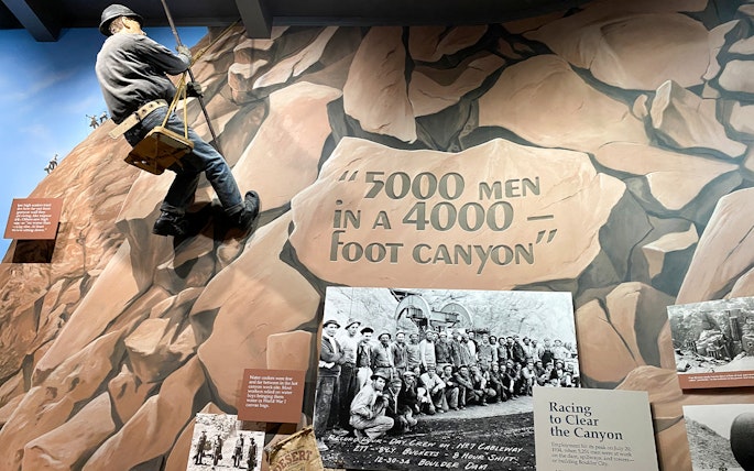 Hoover Dam worker mural and historical photo exhibit at Boulder City and Hoover Dam Museum.