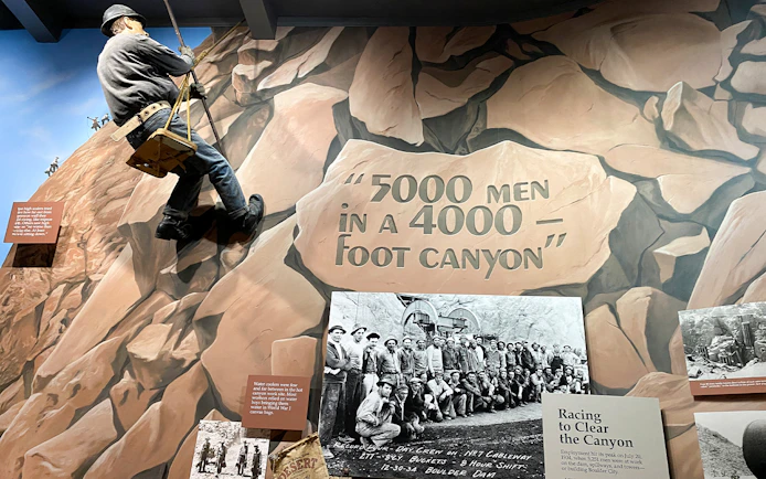 Hoover Dam worker mural and historical photo exhibit at Boulder City and Hoover Dam Museum.