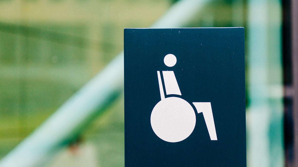 Wheelchair access sign indicating barrier-free entrance in a public area.