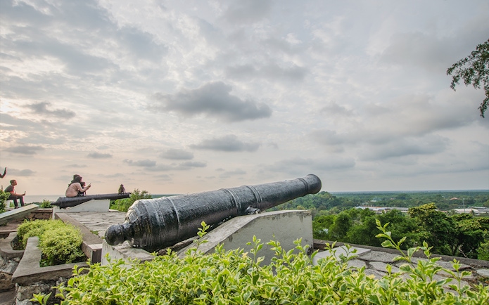 Cannon overlooking lush landscape at Malawati Hill near Batu Caves, Kuala Lumpur.