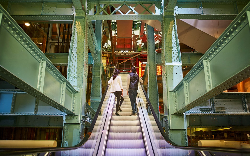 Guests on escalator inside Guinness Storehouse, Dublin.