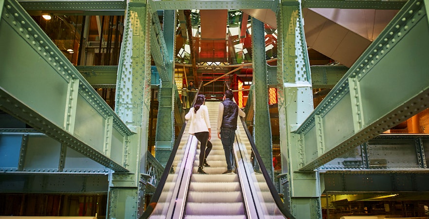 Guests on escalator inside Guinness Storehouse, Dublin.