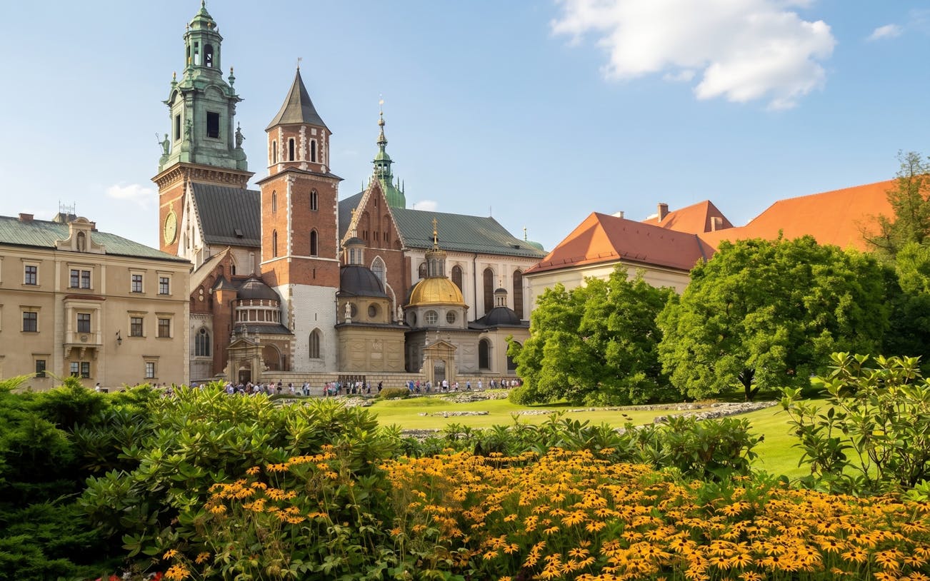 Wawel Castle and Cathedral in Krakow with gardens in the foreground.