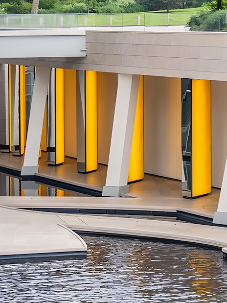 Foundation Louis Vuitton modern architecture with illuminated columns and water feature, Paris.