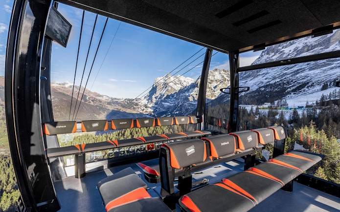 Jungfraujoch cable car interior with panoramic view of snow-capped Alps, Switzerland.
