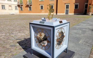 Clock sculpture in the courtyard of Warsaw Royal Castle during guided tour.