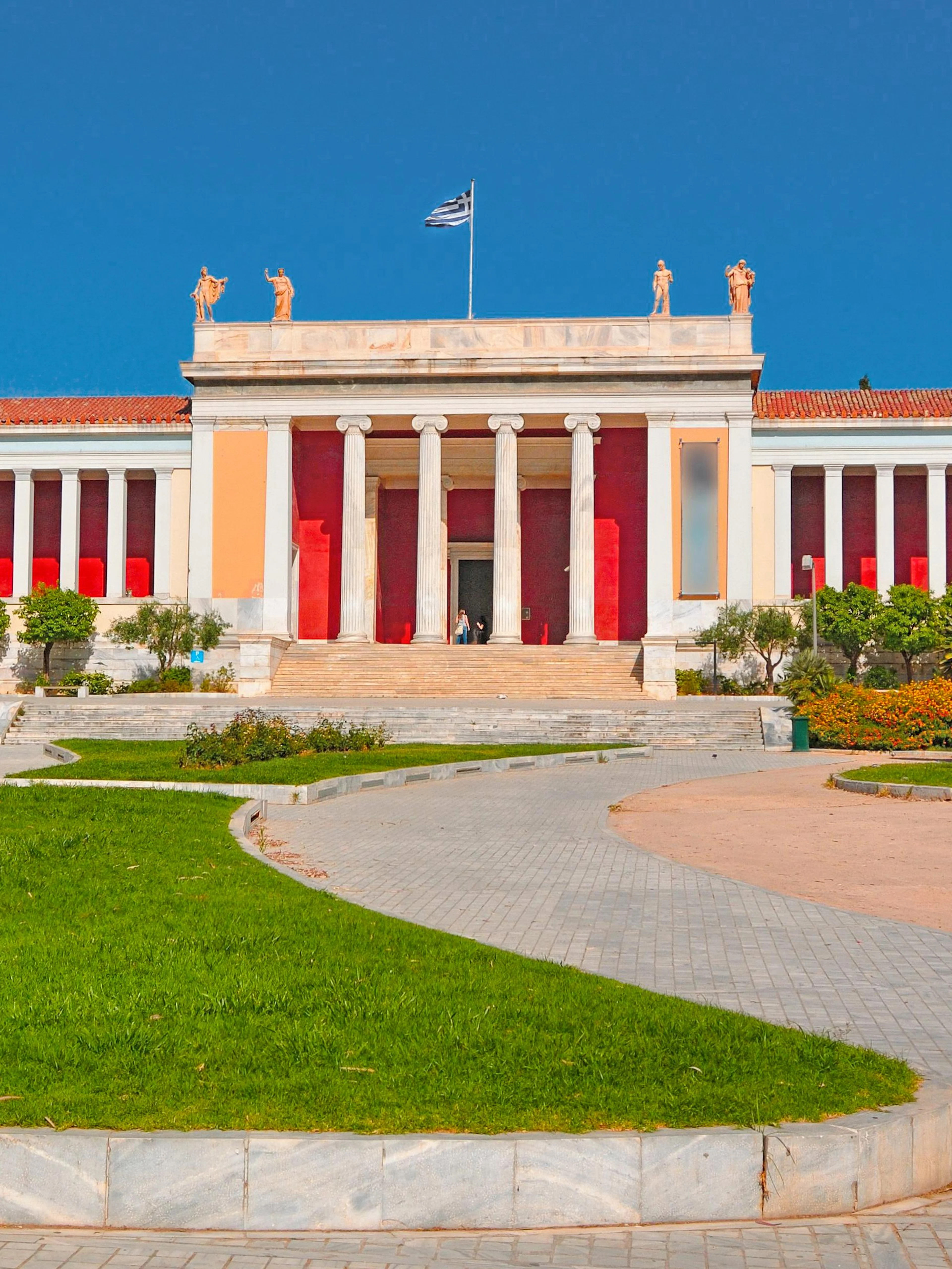 National Archaeological Museum entrance with Greek flag, Athens, Greece.