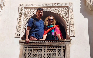 Visitors at an ornate window in Fes Medina during the Chouara Tannery Walking Tour.
