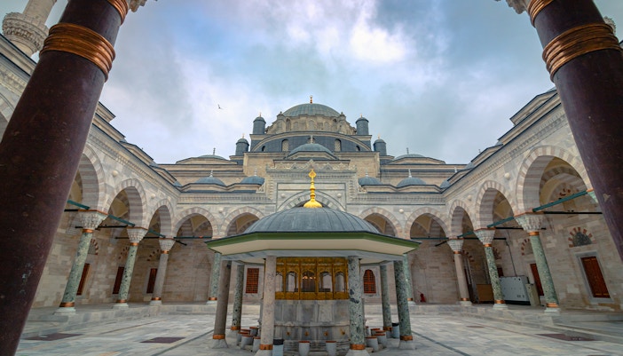 Courtyard of Suleymaniye Mosque with domes and arches, Istanbul tour.