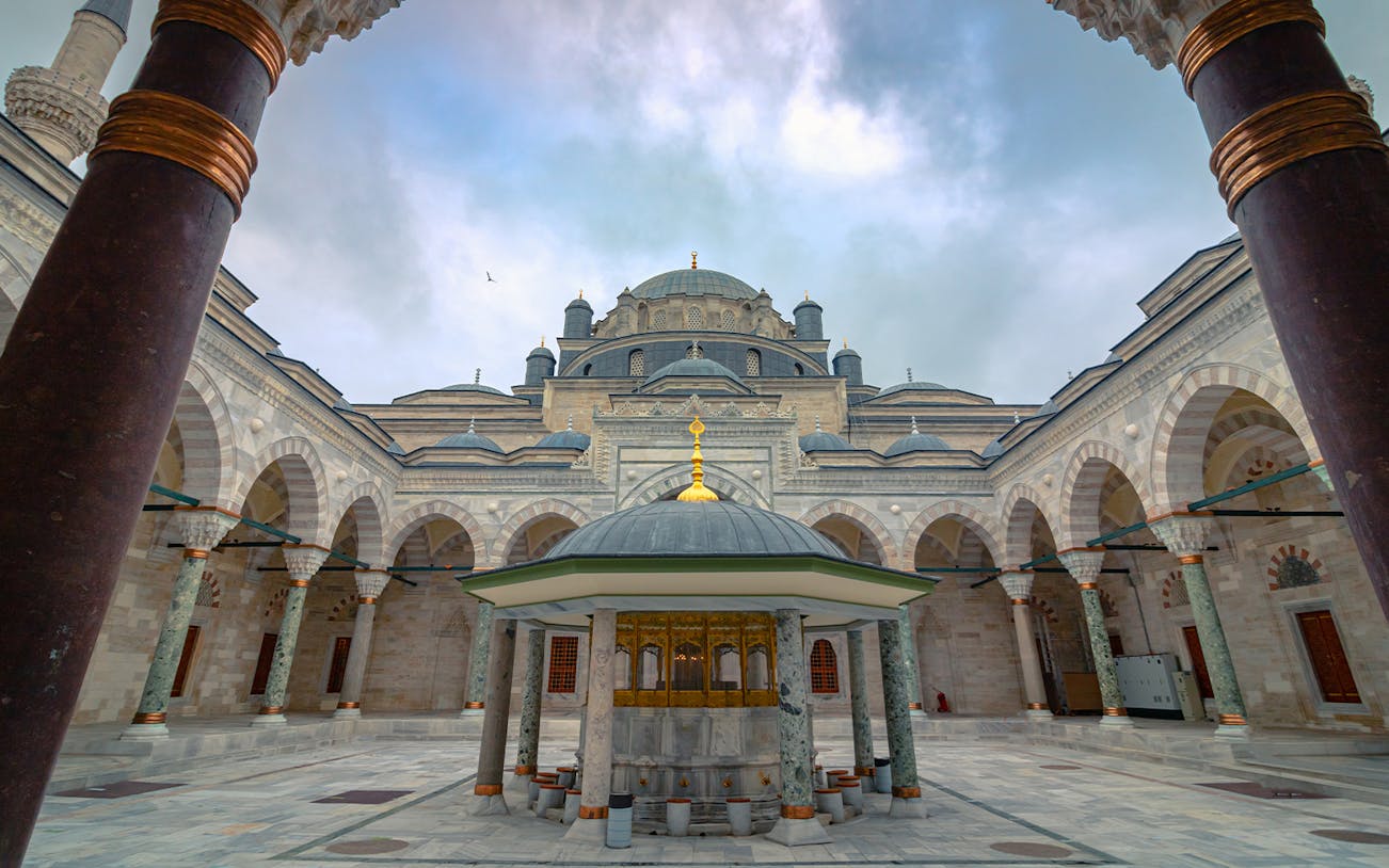 Courtyard of Suleymaniye Mosque with domes and arches, Istanbul tour.