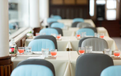 Dining tables set with drinks inside Meridian Cruise, Bangkok.