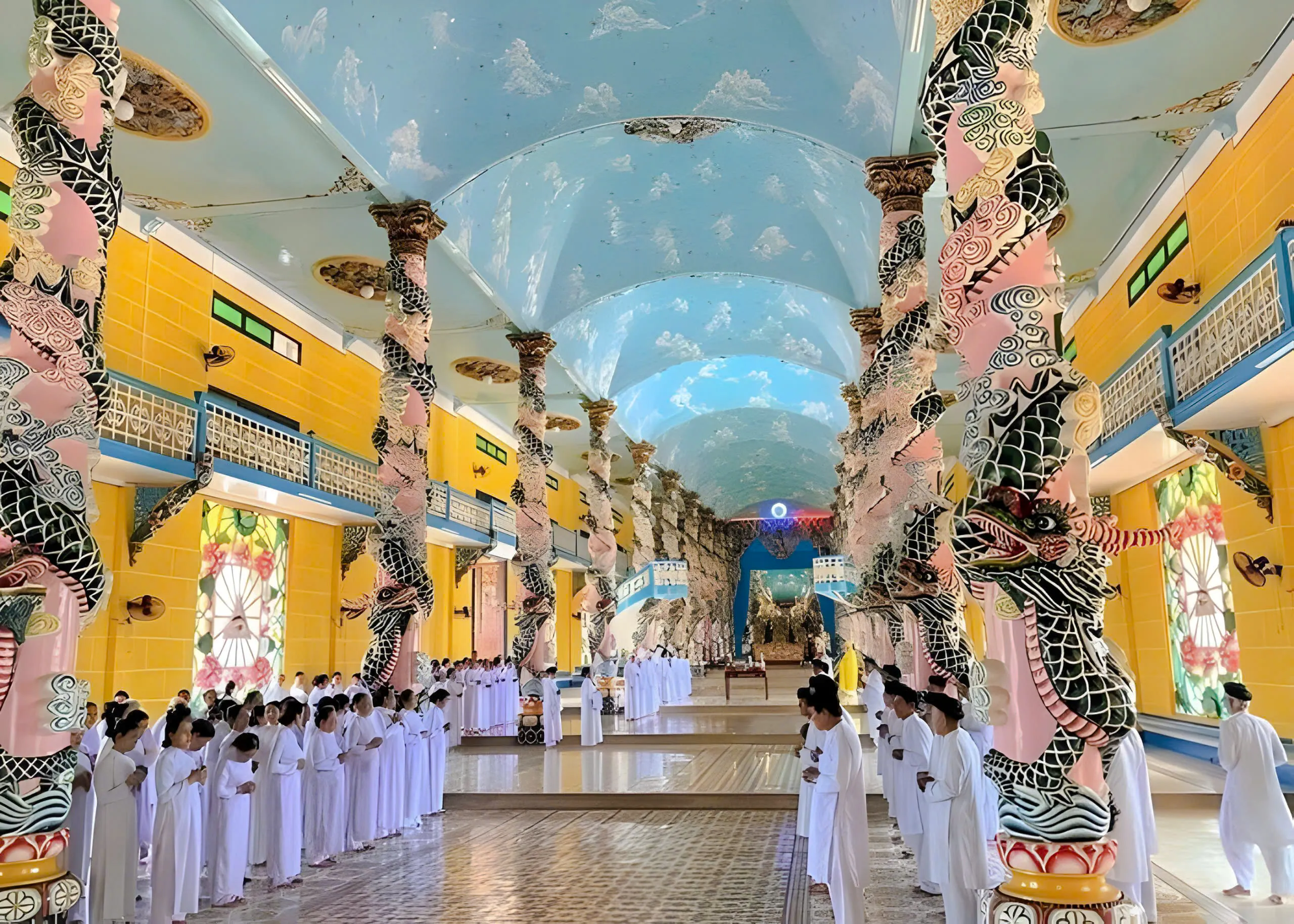 Cao Dai temple interior with worshippers in white robes, Tay Ninh, Vietnam.