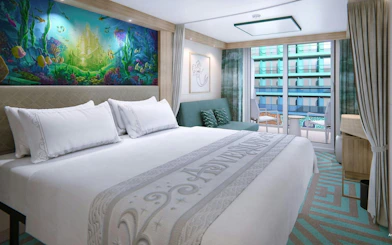 Deluxe room with ocean-themed mural and verandah view.