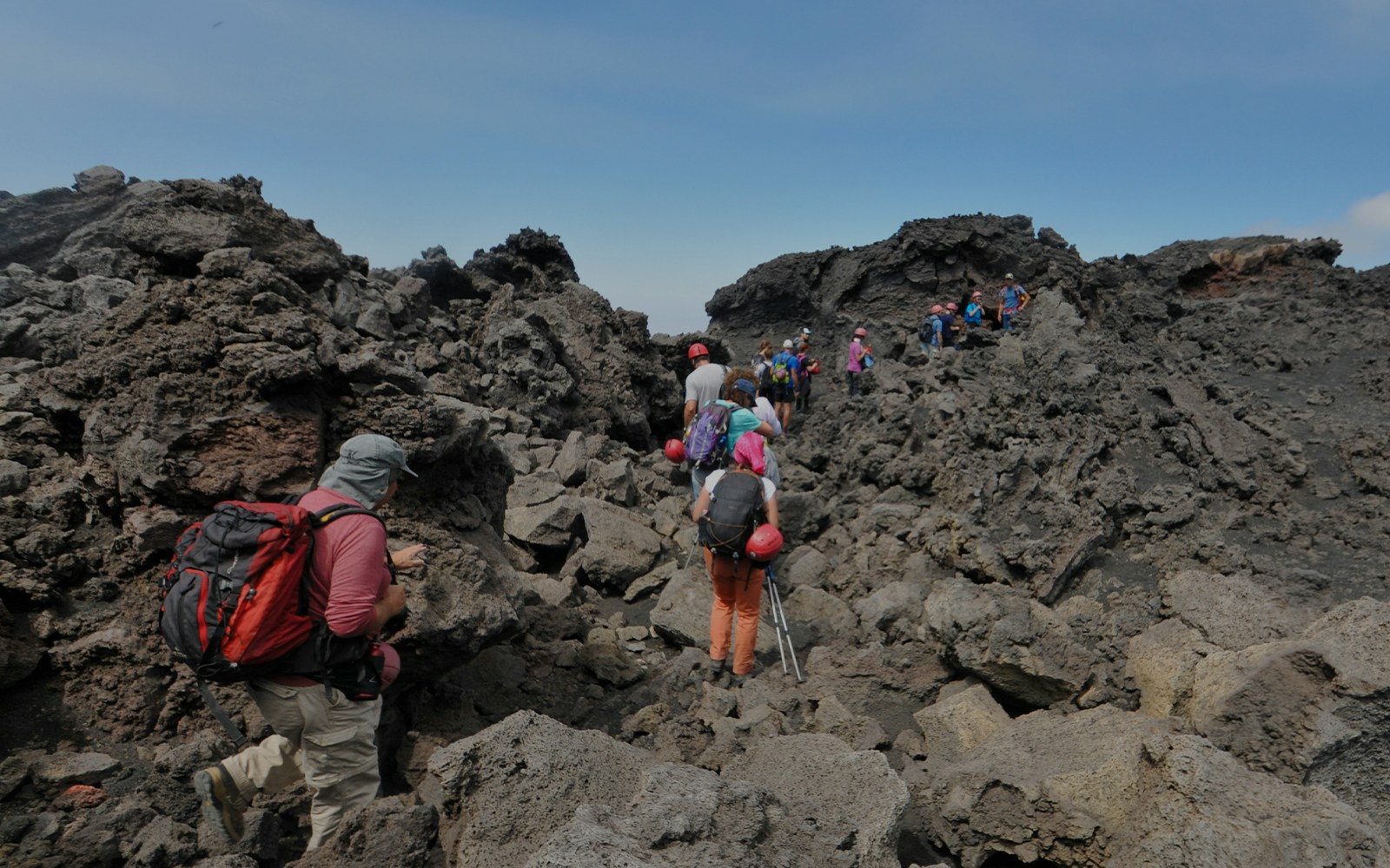 Mount Etna summit trek with hikers navigating rocky terrain