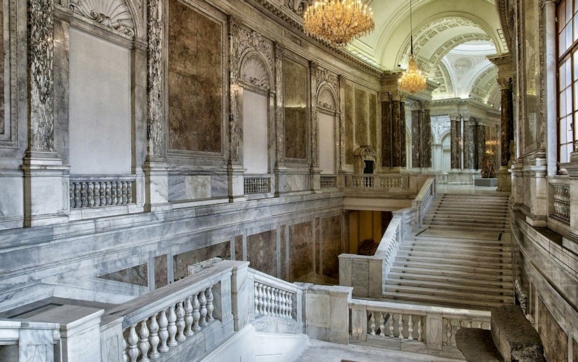 Hofburg Palace grand staircase with ornate marble columns in Vienna, Austria.
