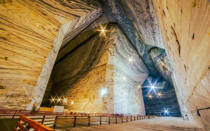 Interior view of Slanic Salt Mine with illuminated cavern walls and pathways.