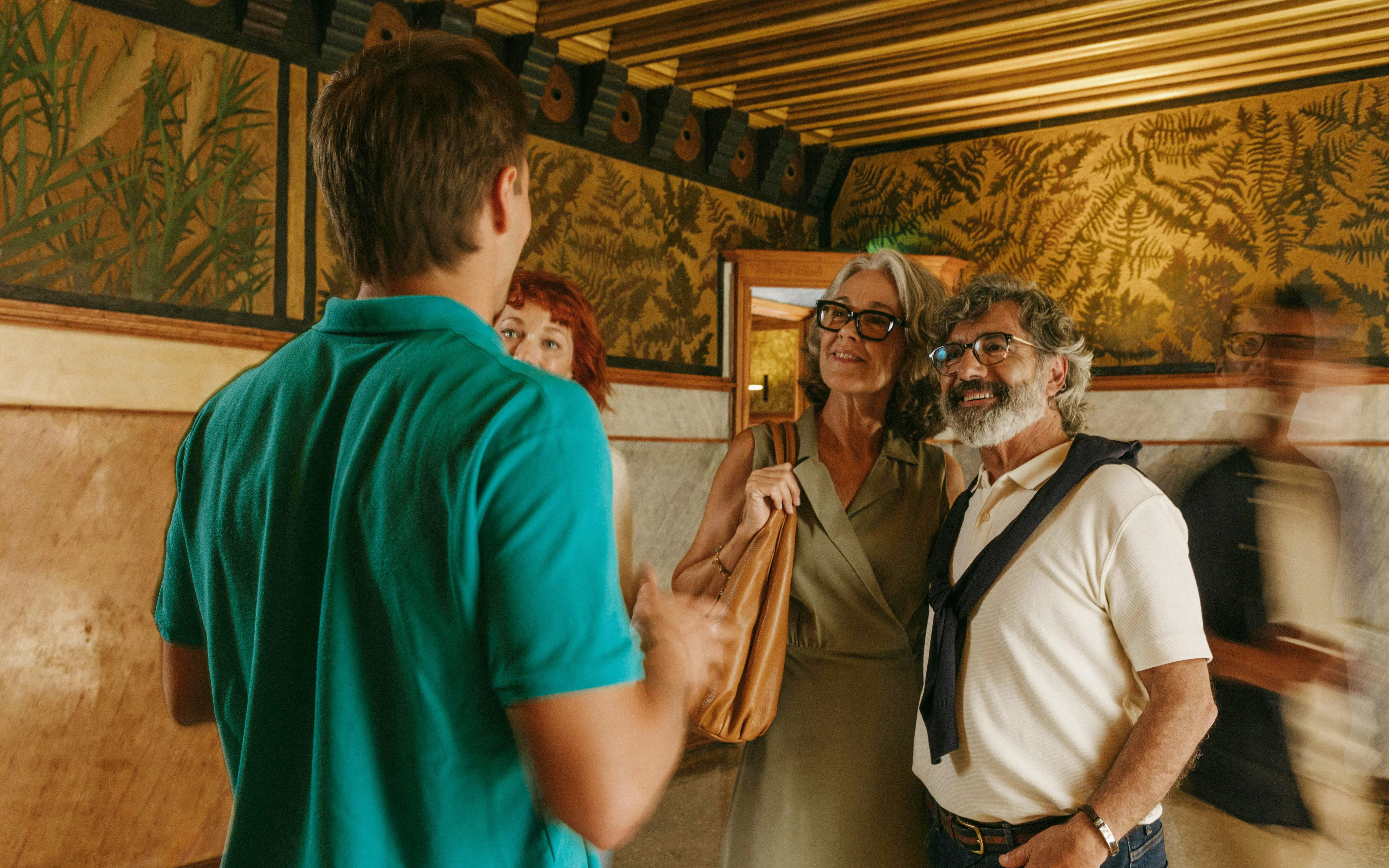 Tour group inside Casa Vicens, Barcelona, with guide explaining wall art.