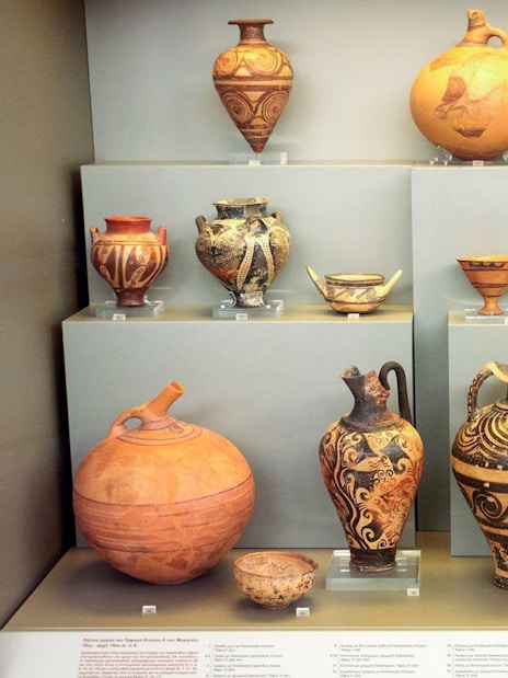 Ancient pottery display at Mycenae archaeological museum.