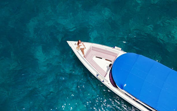 Lady relaxing on a speedboat in Maya Bay, Thailand.