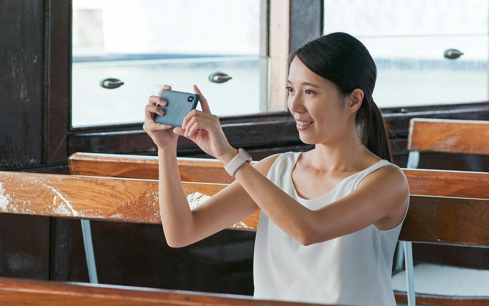 Person taking a photo on a ferry 