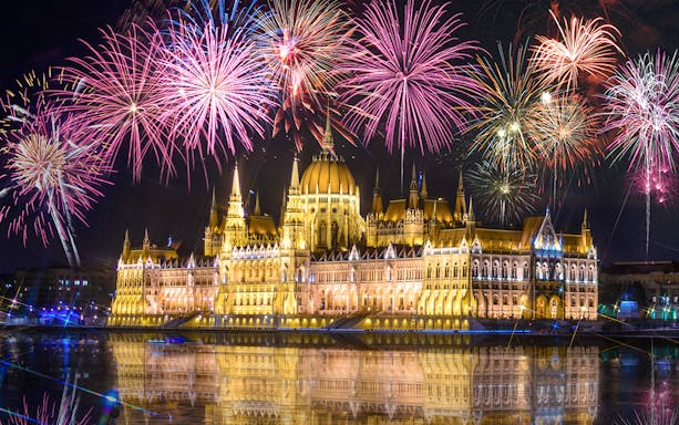 Budapest Parliament with fireworks during New Year's Eve cruise on the Danube.