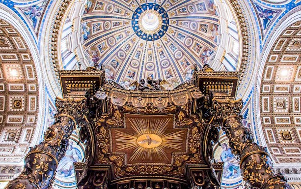 St. Peter's Baldachin with ornate bronze columns under the dome of St. Peter's Basilica, Vatican City.