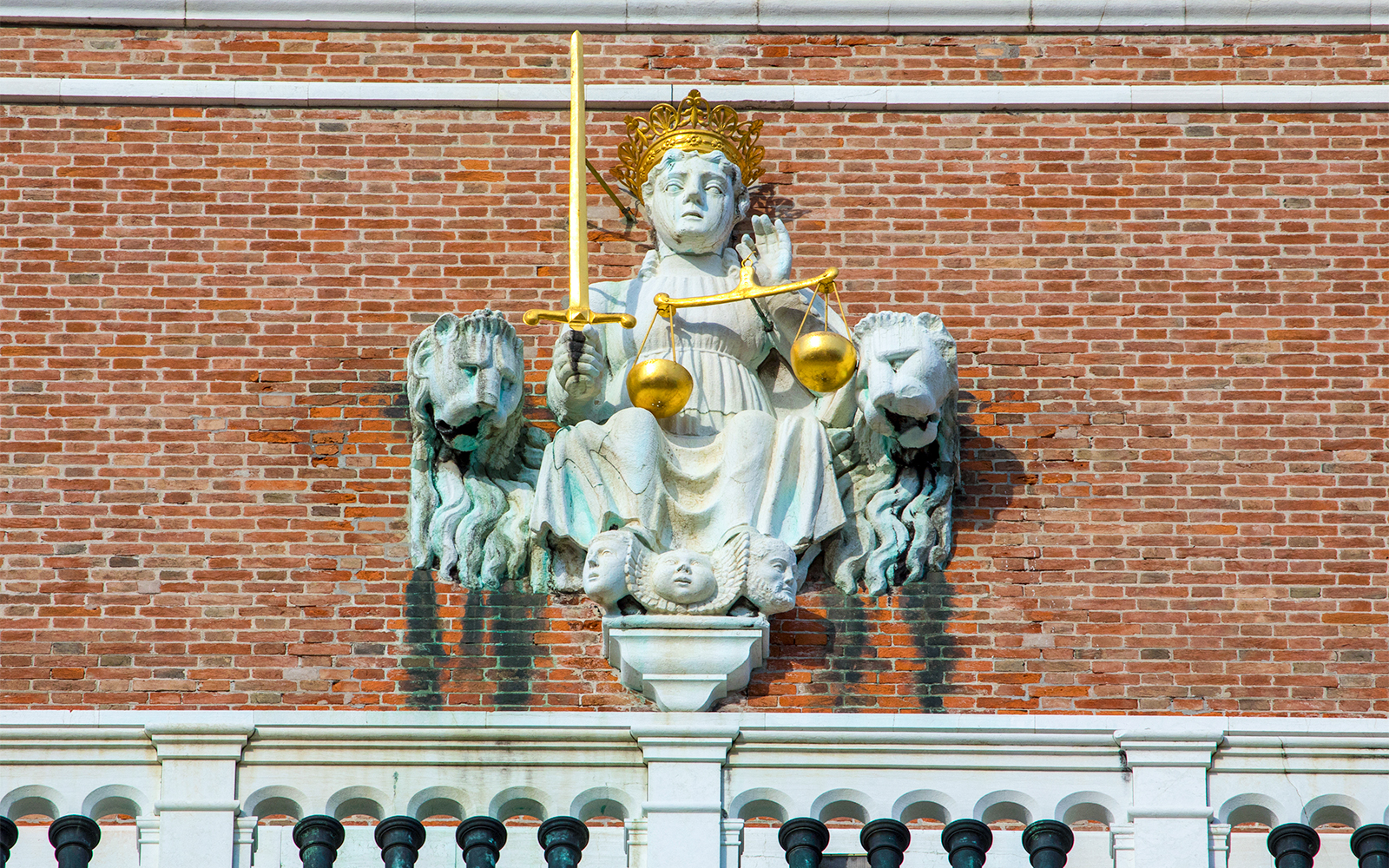Allegorical figure of Venice as Justice near St. Mark's Bell Tower, Venice, Italy.
