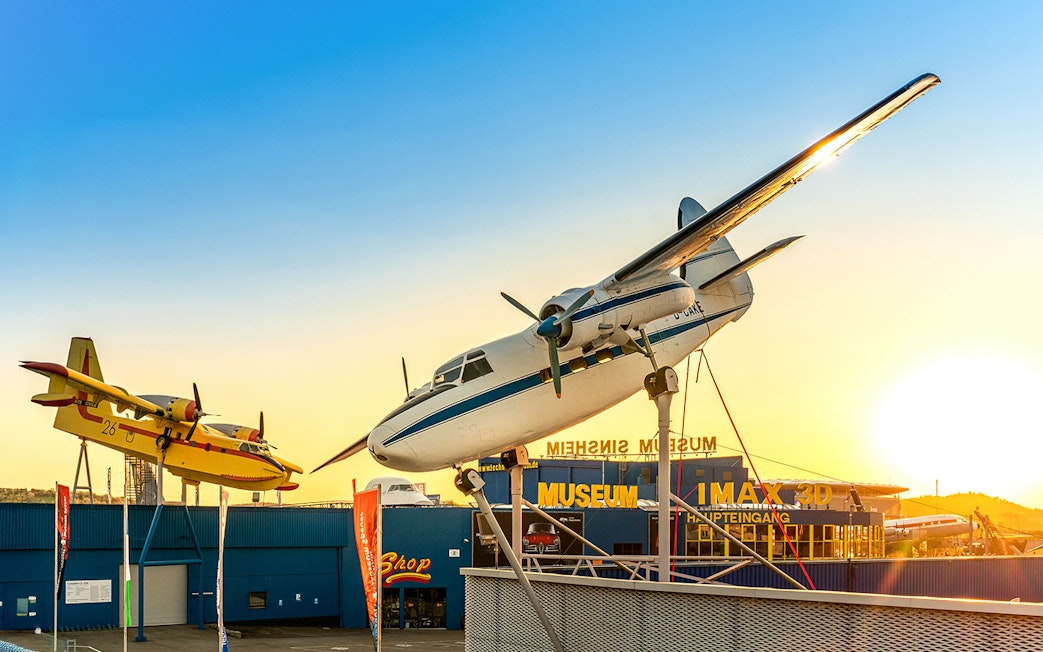 Aircraft display at Technik Museum Sinsheim with sunset backdrop.