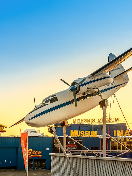 Aircraft display at Technik Museum Sinsheim with sunset backdrop.