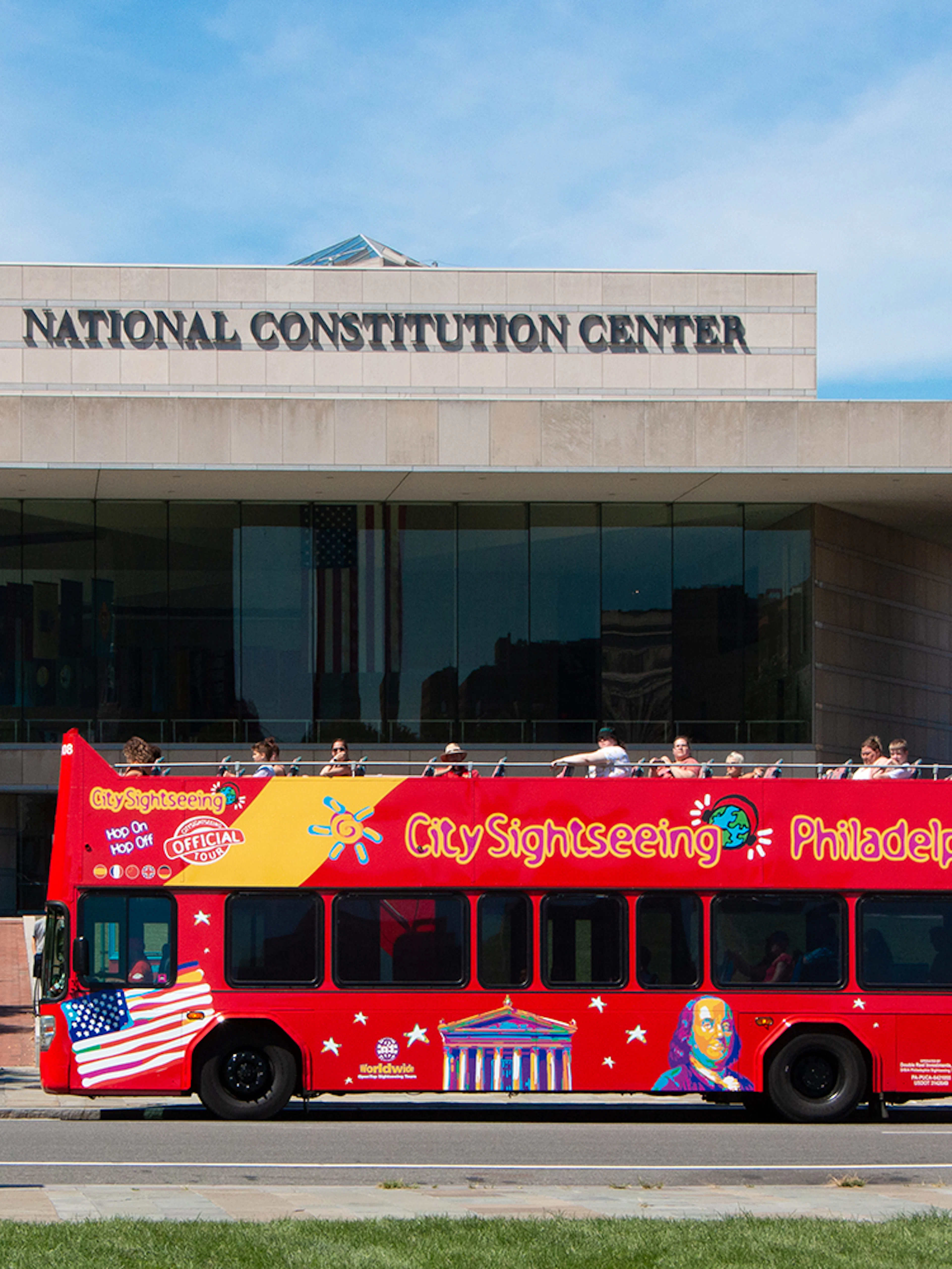 Red double-decker bus in front of the National Constitution Center, Philadelphia Hop-On-Hop-Off Tour.