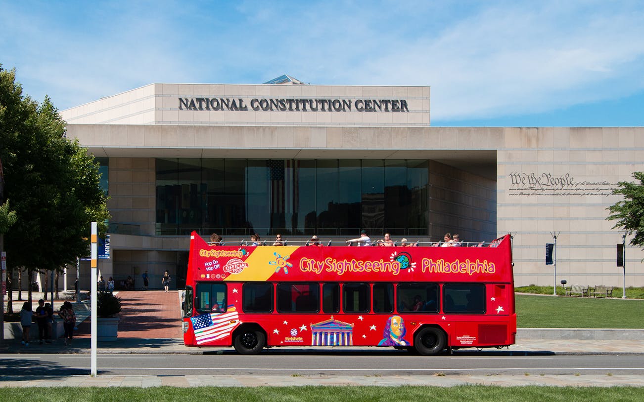 Red double-decker bus in front of the National Constitution Center, Philadelphia Hop-On-Hop-Off Tour.