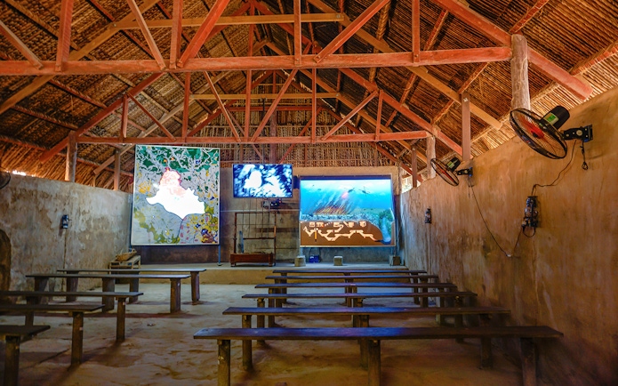 Film room with benches and screens at Cu Chi Tunnels, Vietnam.