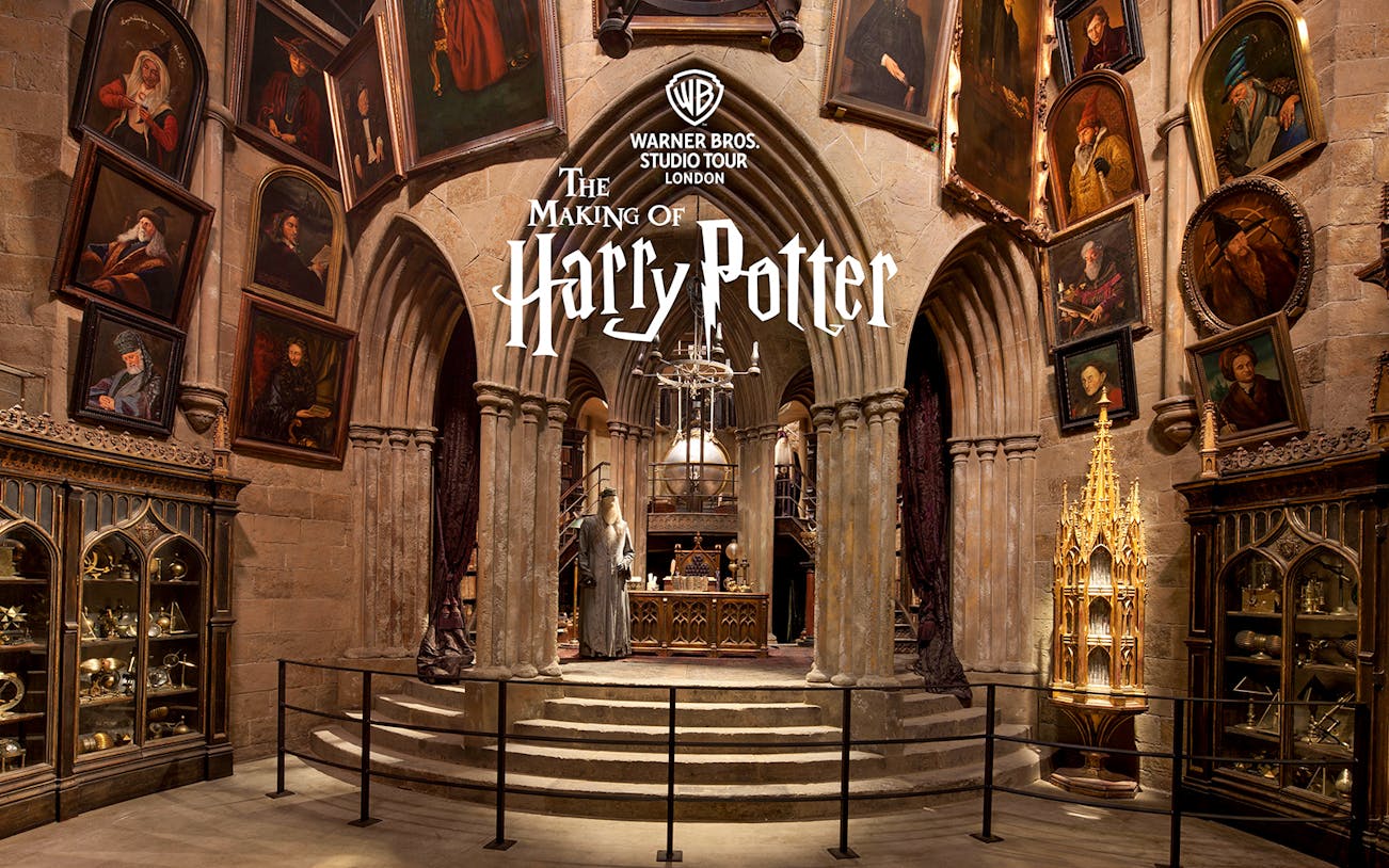Dumbledore's office set at Warner Bros Studio Tour London, featuring portraits and magical artifacts.