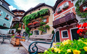 Colorful houses and flower-adorned balconies in Hallstatt, Austria, seen on a day trip from Vienna.