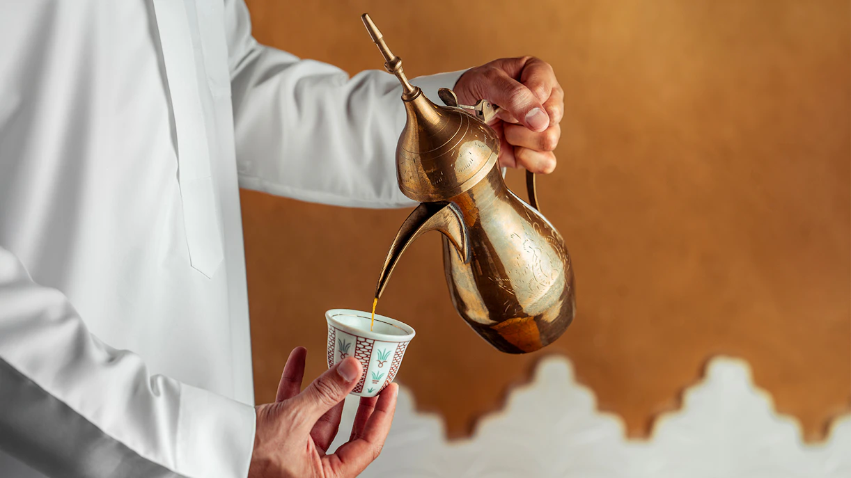 Pouring mint tea from a brass teapot during Agafay Desert quad biking tour.